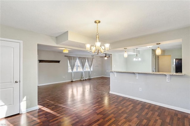 interior space with dark hardwood / wood-style floors and an inviting chandelier