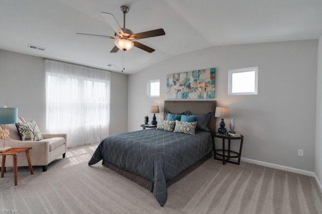 carpeted bedroom featuring lofted ceiling, multiple windows, and ceiling fan