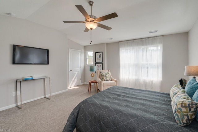 bedroom with ceiling fan, vaulted ceiling, and light colored carpet