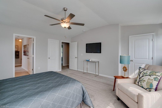 carpeted bedroom with lofted ceiling, ensuite bath, and ceiling fan