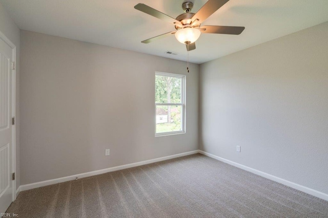 carpeted empty room featuring ceiling fan