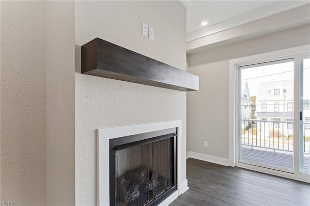 details with a multi sided fireplace and wood-type flooring