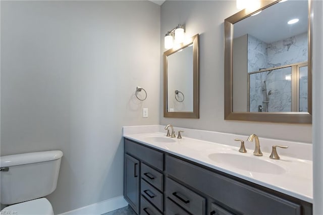 bathroom with toilet, vanity, and a shower with shower door