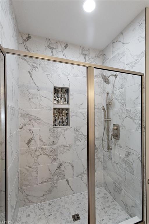 bathroom featuring a shower with shower door