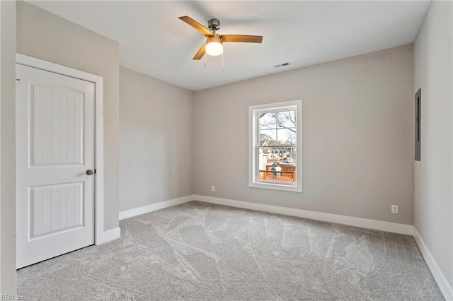 unfurnished room with ceiling fan and light colored carpet