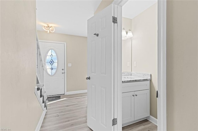 foyer entrance with light hardwood / wood-style flooring