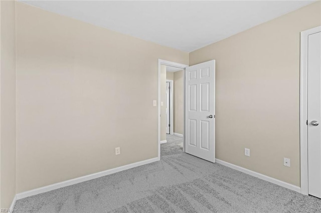 unfurnished bedroom featuring light carpet