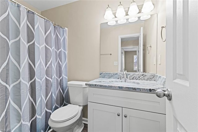 bathroom featuring toilet and vanity