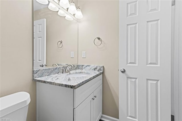 bathroom with toilet and vanity