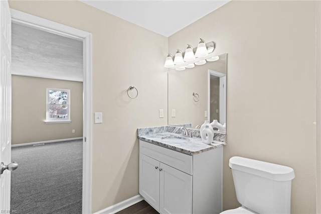 bathroom featuring toilet and vanity