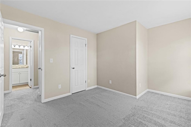 unfurnished bedroom featuring light carpet