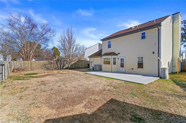 back of house with central air condition unit, a lawn, and a patio