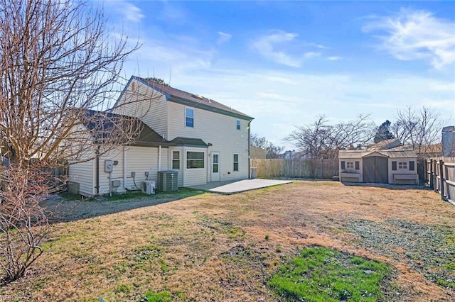 rear view of property featuring a shed, central AC unit, a patio area, and a yard