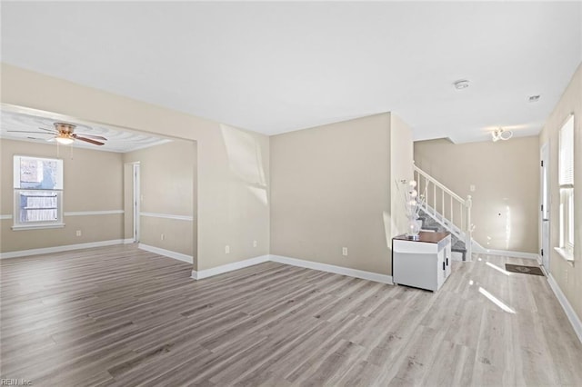 unfurnished living room with ceiling fan and light hardwood / wood-style flooring