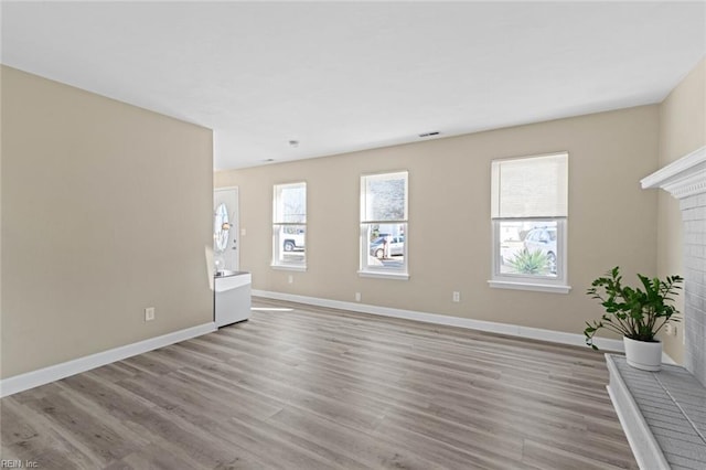 interior space with a fireplace and light hardwood / wood-style flooring