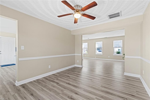 empty room with ceiling fan and light hardwood / wood-style flooring