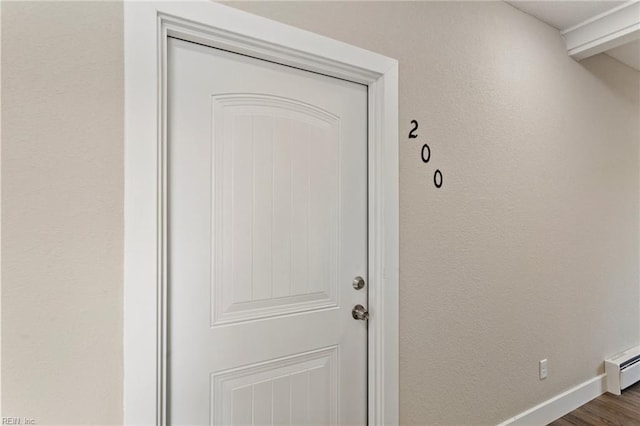 property entrance with a baseboard heating unit