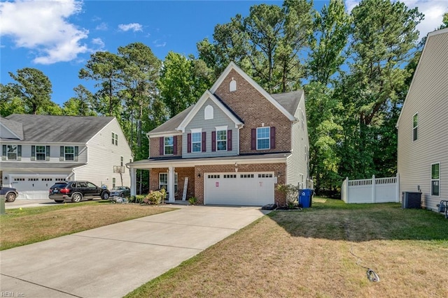 view of front of property featuring a garage, a front yard, and central AC