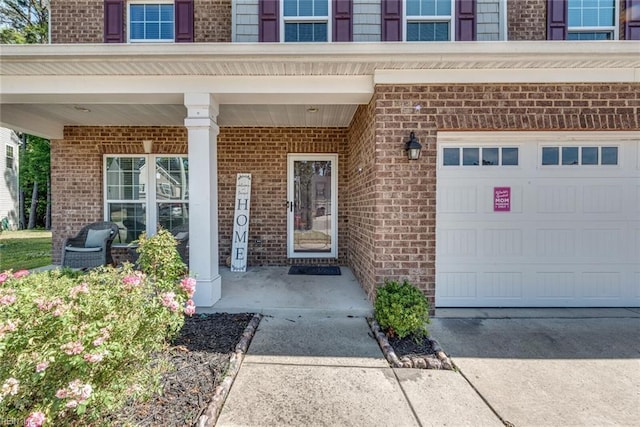 property entrance with a porch and a garage