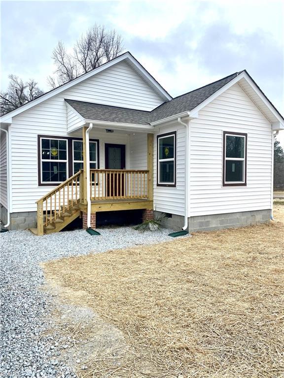 view of front facade with crawl space, a porch, and a shingled roof