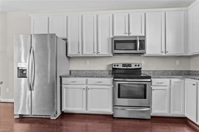 kitchen with appliances with stainless steel finishes, dark hardwood / wood-style flooring, white cabinets, and light stone countertops