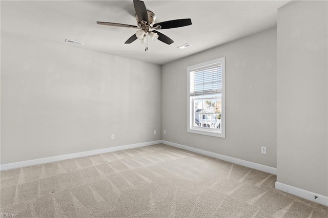 carpeted spare room with ceiling fan