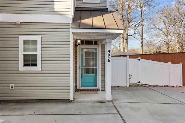 view of exterior entry with a patio