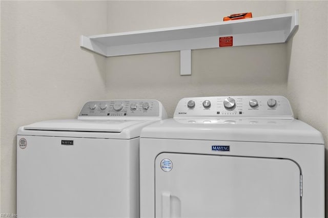 clothes washing area featuring washer and clothes dryer