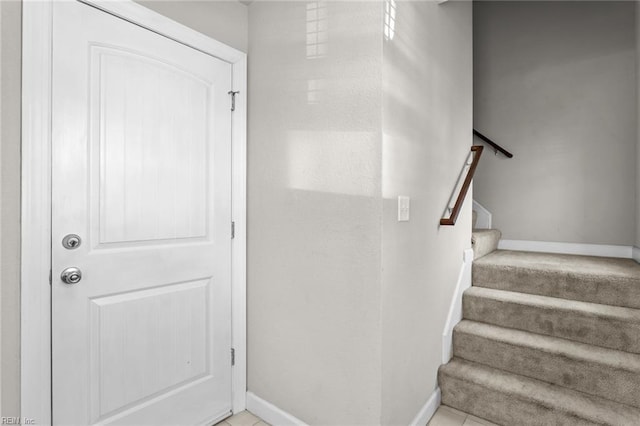 stairway with tile patterned floors