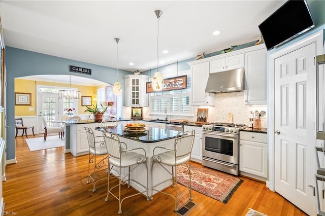 kitchen featuring white cabinets, pendant lighting, and appliances with stainless steel finishes