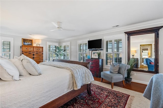 bedroom with wood-type flooring, ceiling fan, and ornamental molding