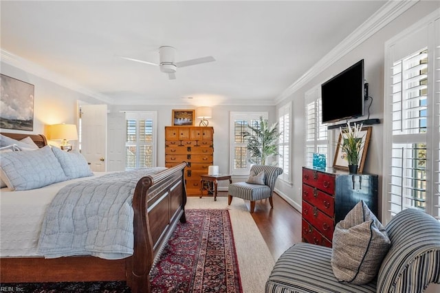 bedroom with ceiling fan, crown molding, multiple windows, and wood-type flooring