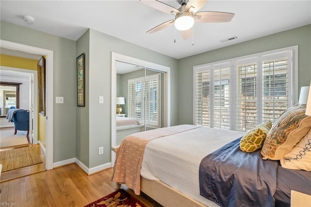 bedroom featuring hardwood / wood-style floors, a closet, and ceiling fan