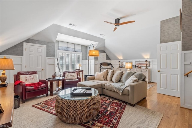 living room featuring lofted ceiling, ceiling fan, and light hardwood / wood-style floors