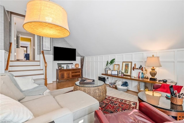 living room featuring vaulted ceiling and hardwood / wood-style flooring