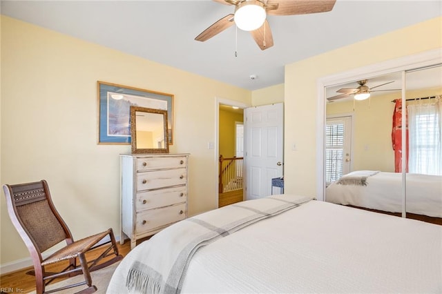 bedroom with wood-type flooring, a closet, and ceiling fan