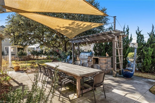 view of patio with exterior kitchen, a bar, grilling area, and a pergola