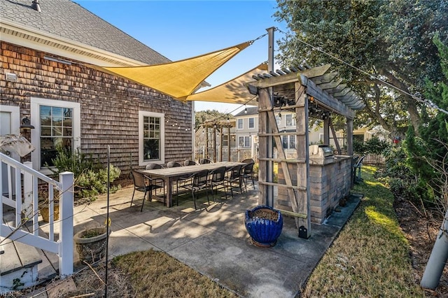 view of patio featuring an outdoor bar and a pergola