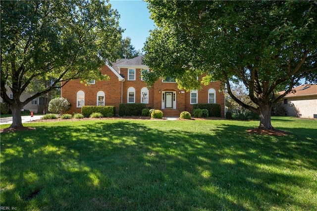 colonial inspired home with a front yard