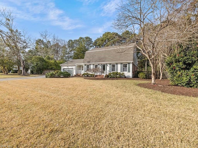 view of front of property with a front lawn and a garage