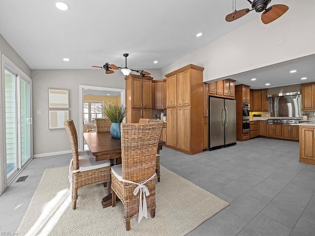 dining area with ceiling fan and vaulted ceiling