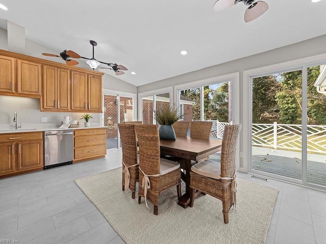 dining area with sink, vaulted ceiling, and light tile patterned floors