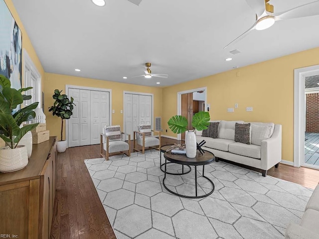 living room with ceiling fan and light hardwood / wood-style flooring