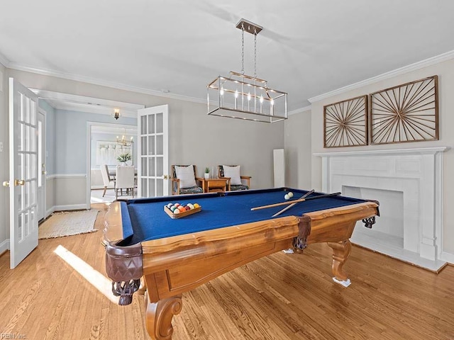 rec room featuring pool table, french doors, ornamental molding, and hardwood / wood-style floors