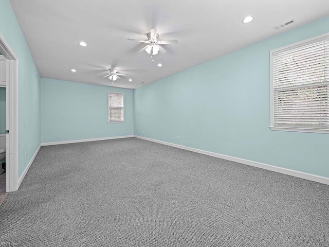 unfurnished room featuring ceiling fan and carpet