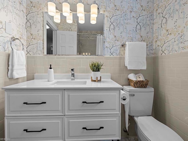 bathroom with toilet, vanity, tile walls, and a shower with curtain