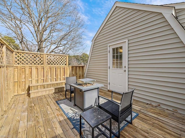 wooden terrace with a fire pit