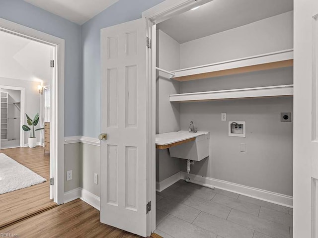 clothes washing area featuring electric dryer hookup, wood-type flooring, and washer hookup