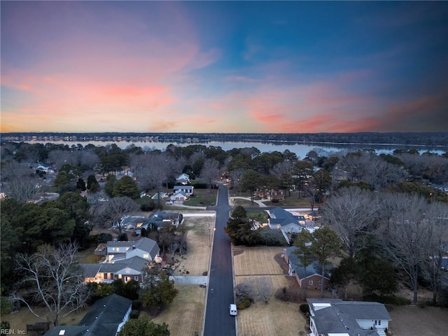 aerial view at dusk with a water view