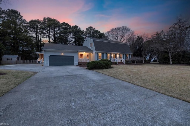 view of front of home featuring a lawn and a garage